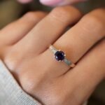 vintage amethyst and diamond solitaire ring in 9k gold worn on hand