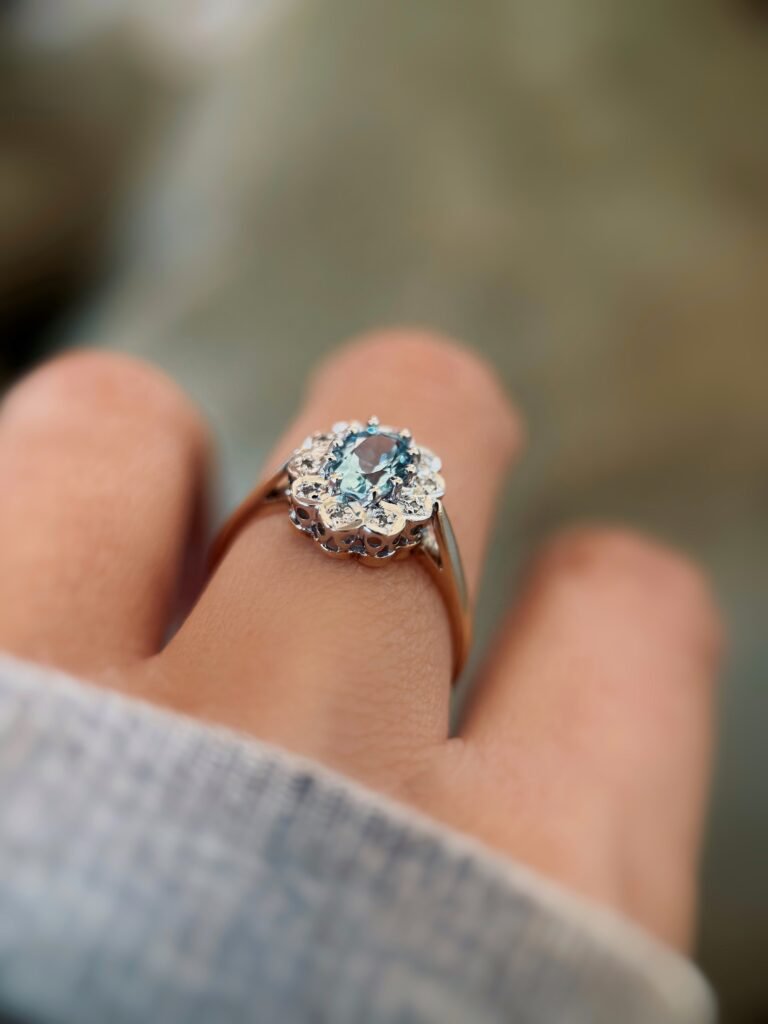 vintage topaz and diamond cluster ring in 9k gold worn on hand