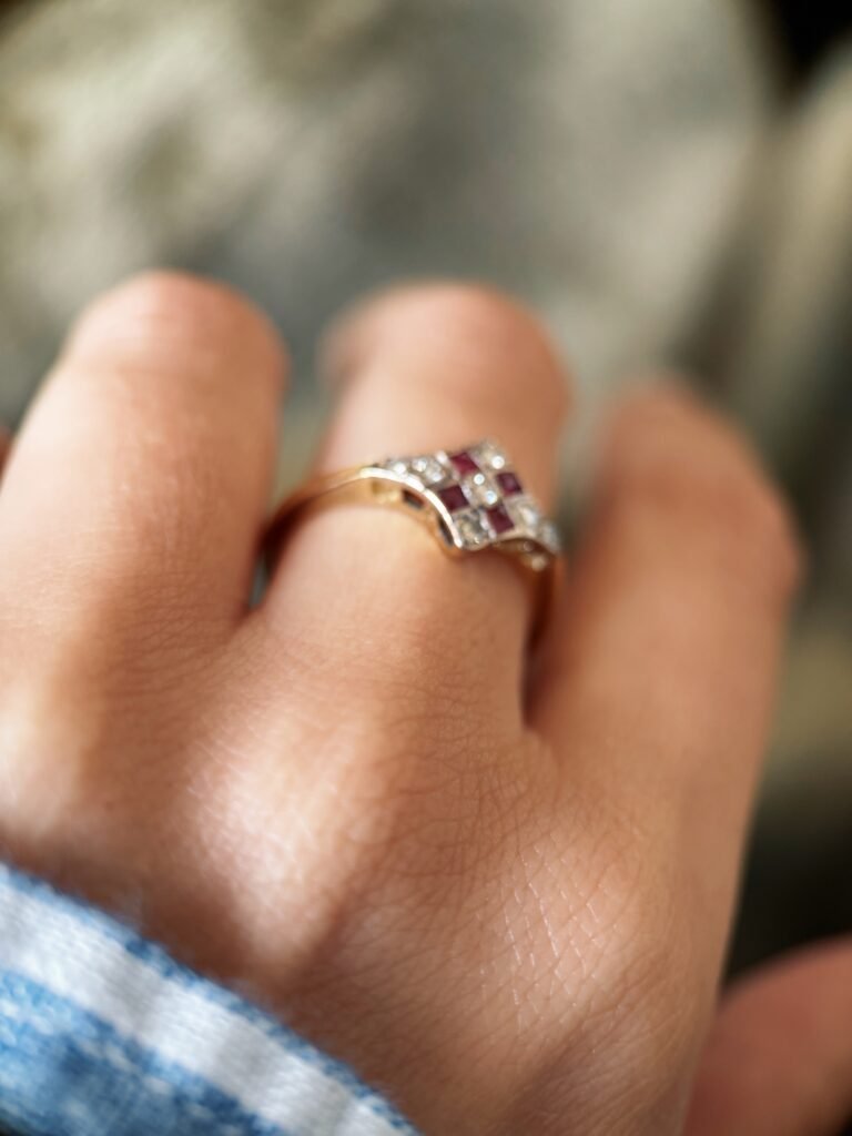 Art deco Ruby diamond cluster ring in 18k gold worn on hand