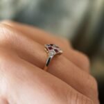 Art deco Ruby diamond cluster ring in 18k gold worn on hand