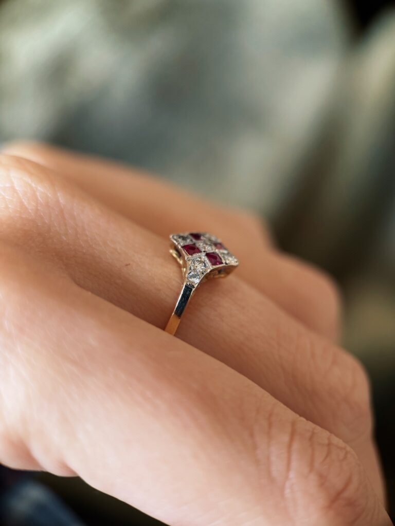 Art deco Ruby diamond cluster ring in 18k gold worn on hand