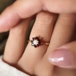 Vintage 9K gold opal and garnet cluster ring worn on a finger