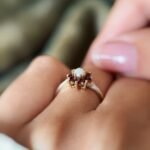 Vintage 9K gold opal and garnet cluster ring worn on a finger