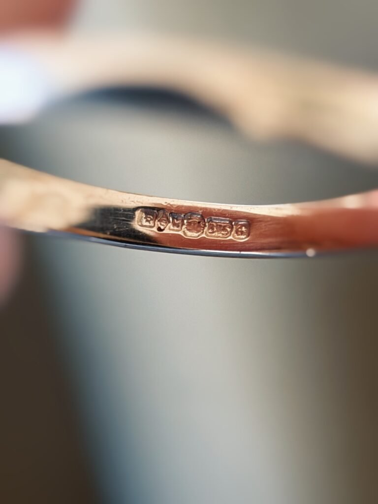 Close-up of English birmingham hallmarks inside a vintage 9 carat gold ring