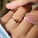 Vintage 9 carat gold swirl ring worn on a hand
