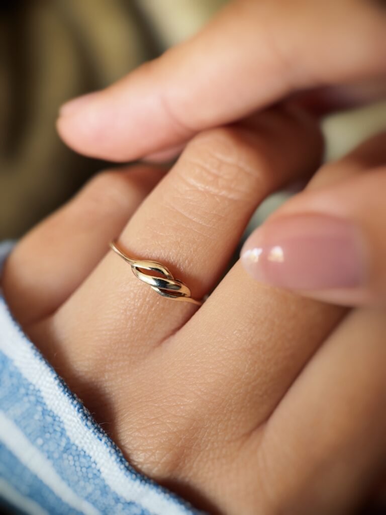 Vintage 9 carat gold swirl ring worn on a hand