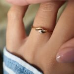 Vintage 9 carat gold swirl ring worn on a hand