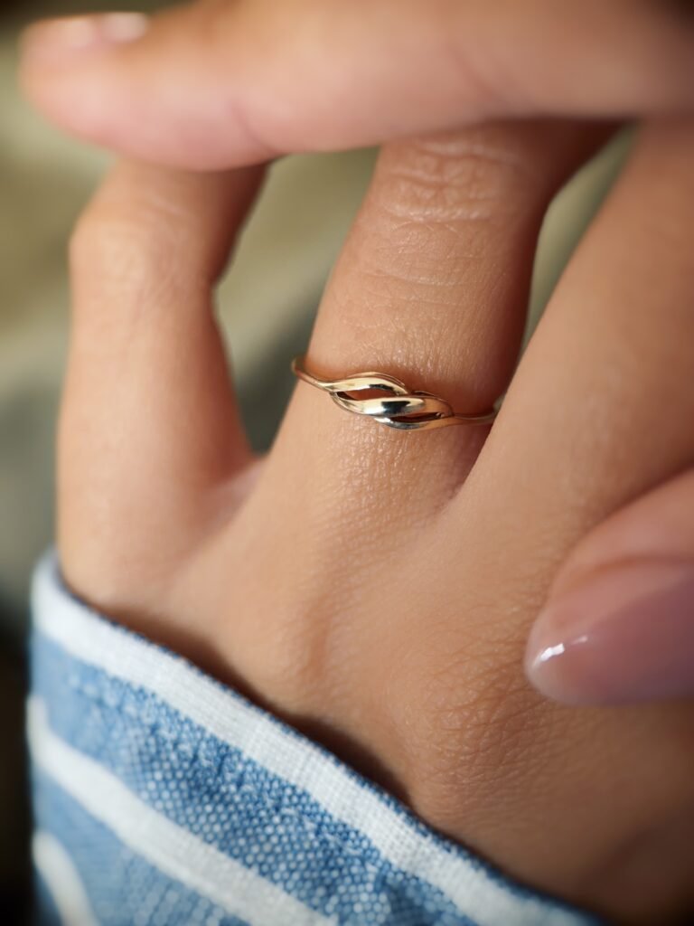 Vintage 9 carat gold swirl ring worn on a hand