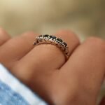 Vintage 9 carat gold five stone sapphire ring worn on a hand