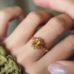 Vintage 9 carat gold yellow citrine cluster ring worn on a hand
