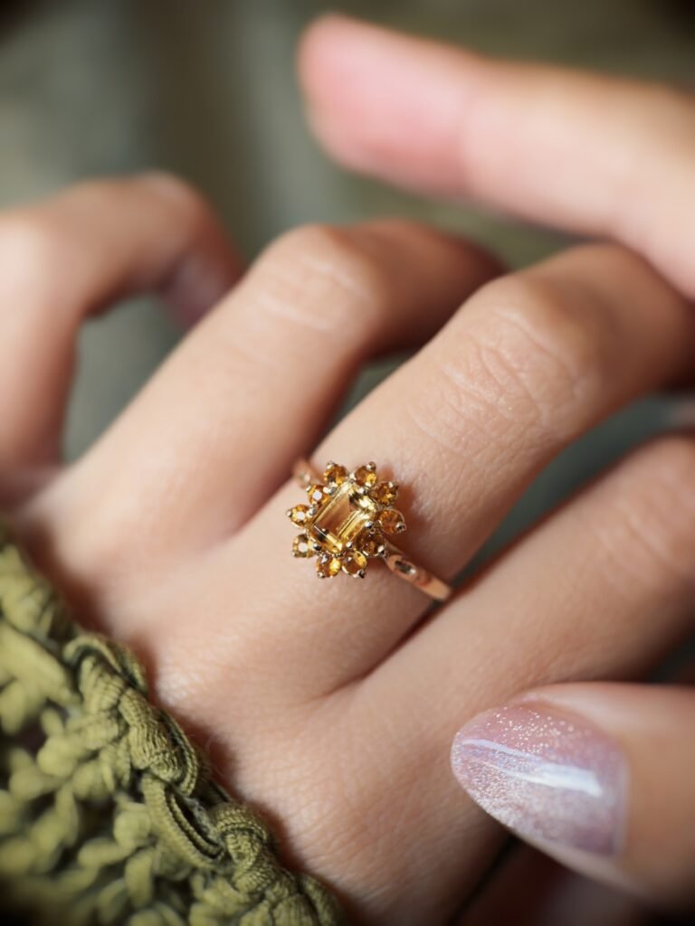 Vintage 9 carat gold yellow citrine cluster ring worn on a hand