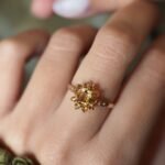 Vintage 9 carat gold yellow citrine cluster ring worn on a hand