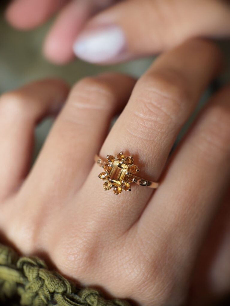 Vintage 9 carat gold yellow citrine cluster ring worn on a hand