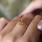 Vintage 9 carat gold yellow citrine cluster ring worn on a hand