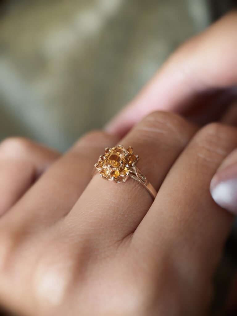 Vintage 9 carat gold yellow citrine cluster ring worn on a hand