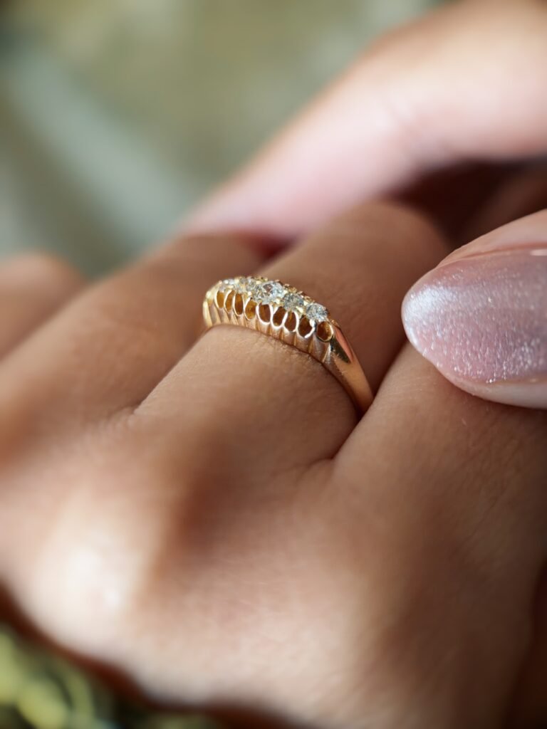 Antique 18 carat gold old european cut diamond fivestone ring worn on a hand