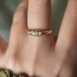 Antique 18 carat gold old european cut diamond fivestone ring worn on a hand