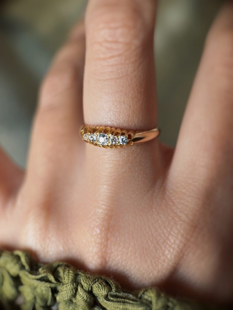 Antique 18 carat gold old european cut diamond fivestone ring worn on a hand