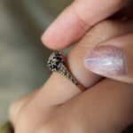 Vintage 9 carat gold sapphire and diamond triple daisy ring worn on a hand