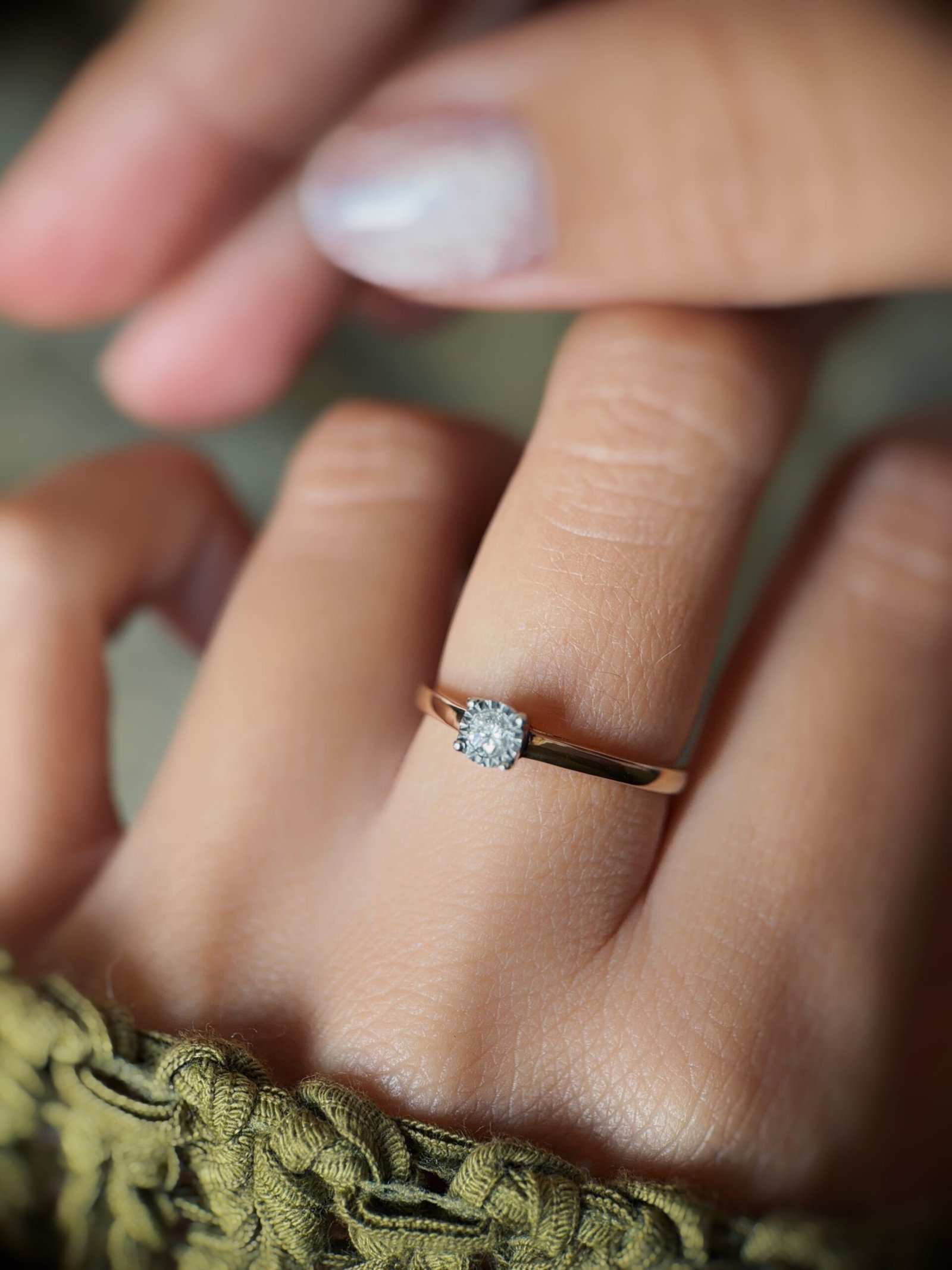 Vintage 9 carat gold diamond solitaire ring worn on a hand