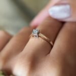 Vintage 9 carat gold diamond solitaire ring worn on a hand
