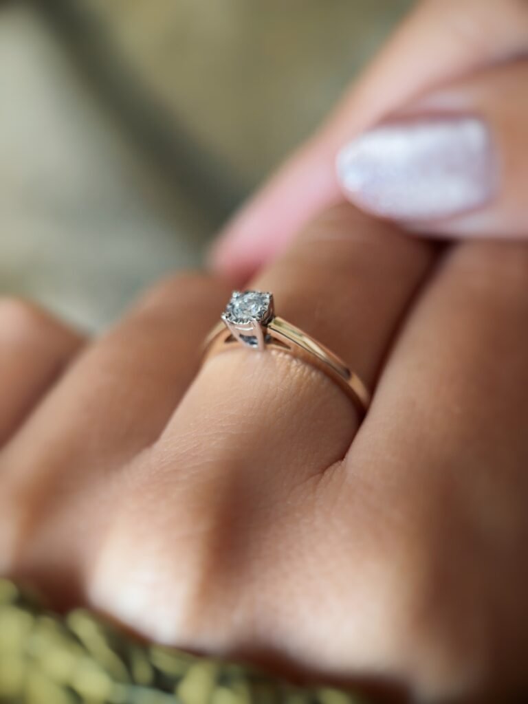 Vintage 9 carat gold diamond solitaire ring worn on a hand