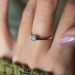 Vintage 9 carat gold diamond solitaire ring worn on a hand