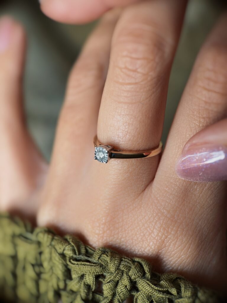 Vintage 9 carat gold diamond solitaire ring worn on a hand