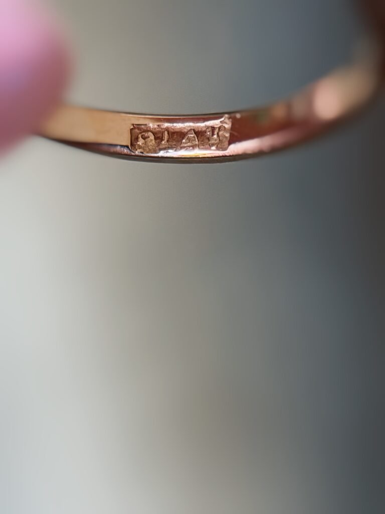 Close-up of English hallmarks inside a antique 18 carat gold ring