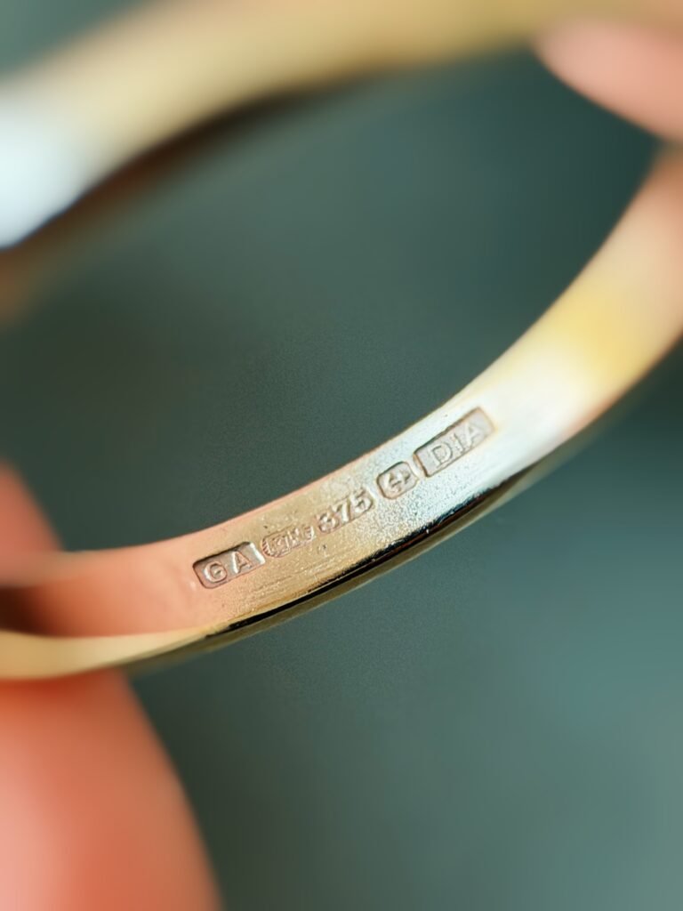 Close-up of English hallmarks inside a vintage 9 carat gold ring