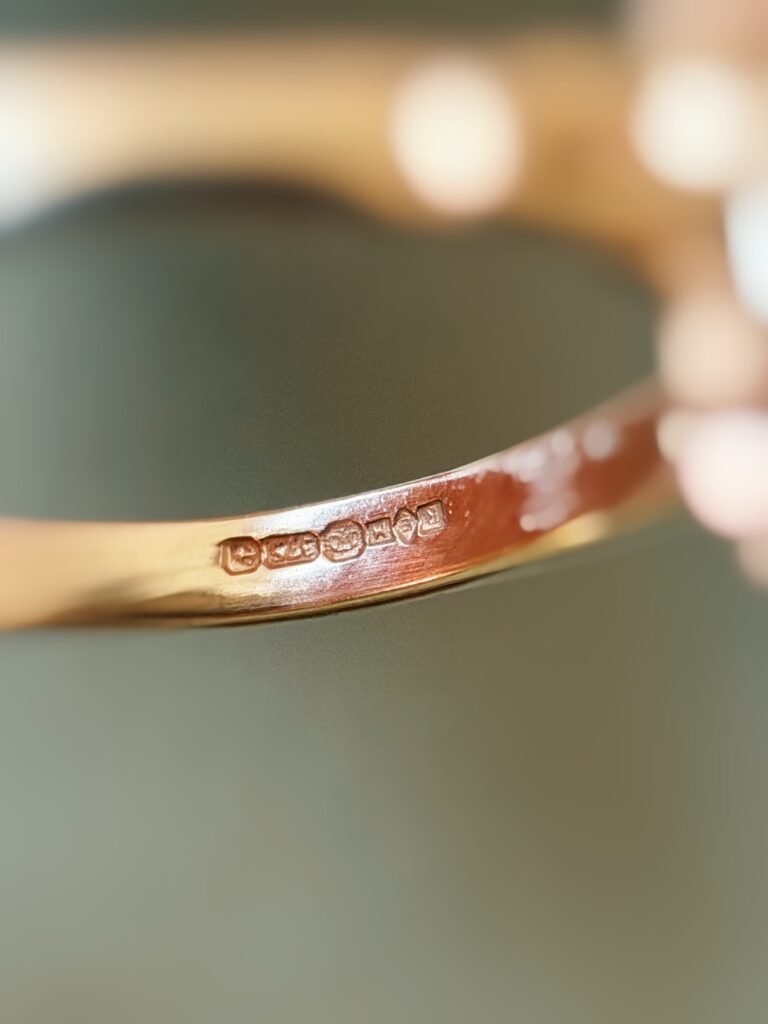 Close-up of English hallmarks inside a vintage 9 carat gold ring